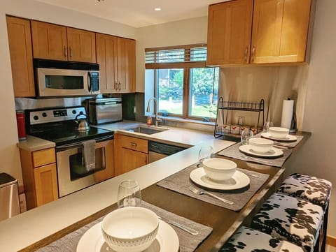 Our kitchen is small but mighty featuring a stove/oven, sink, dishwasher, fridge/freezer, microwave, toaster and Keurig coffee maker.