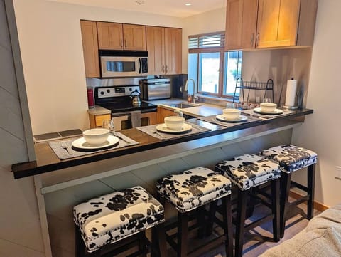 The kitchen bar has seating for four.