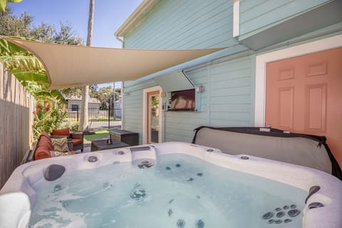 Spacious and relaxing patio with hot tub, fire table,  and smart TV.