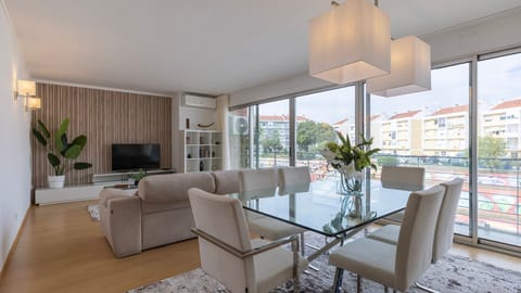 Unwind in this expansive living and dining area, flooded with natural light from floor-to-ceiling windows #LivingDining #NaturalLight #CityView #SpaciousLiving #ModernDesign #EntertainmentReady