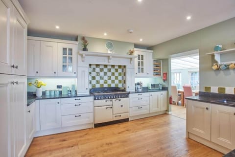 Tamarisk House, Newquay. Ground floor: Kitchen with a fabulous range cooker, breakfast bar, dishwasher, fridge/freezer and comfortable seating area
