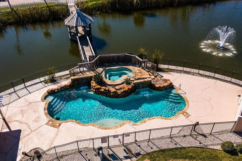 `Tropical-Style Pool Overlooking Lagoon with Serene Fountain Views`