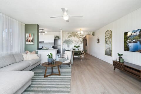 Open-plan living and dining layout with ceiling fan.