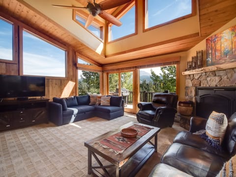 Bright & spacious living area with plenty of seating, large TV and gas fireplace
