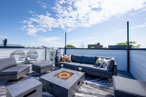 4th Floor: Rooftop deck a fire pit with outdoor lounging surrounded by city and neighborhood views. Rooftop also features yard games like corn hole and giant Connect-Four.