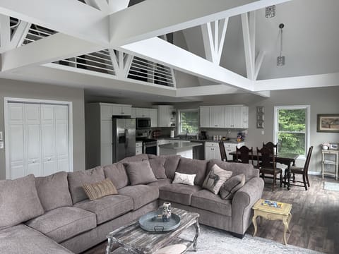living area on main floor with open ceiling and natural light 