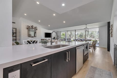 Kitchen Island: built in sink, dishwasher and microwave. Bar seating for three.