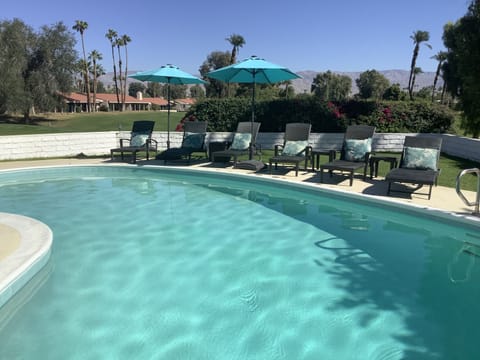 Backyard Oasis: six lounge chairs, side tables, umbrellas, views of golf course