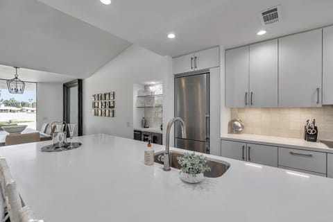 Built in Bar: glassware, Ninja blender and wine & beverage refrigerator.