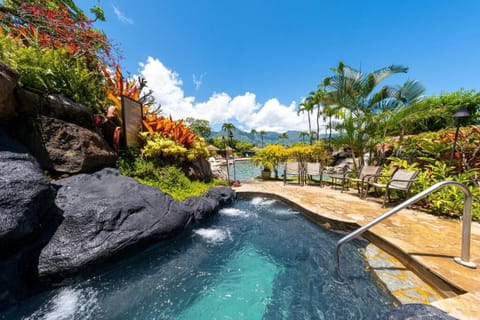 Slip into bubbling water beside cascading rock waterfalls.