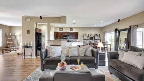 Our spacious living room beckons with a massive, plush grey sofa that practically envelops you in relaxation.