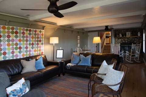 Living Room - 2 couches, 2 wood Rockers, chair, TV, Fireplace, table & 4 chairs.