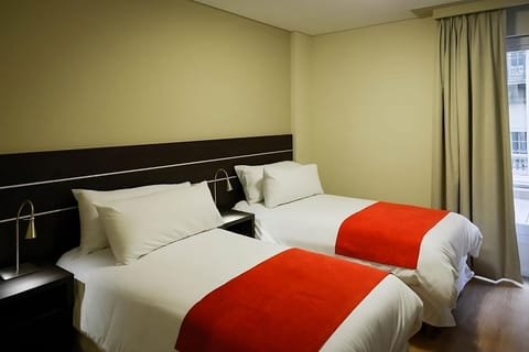 Drift off in tidy twin beds with soothing, simple decor.