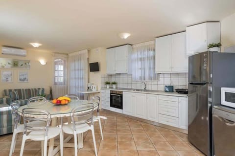 Modern Kitchen Featuring Dining Table and Comfortable Sofas