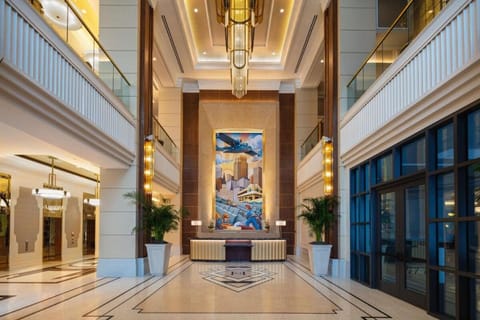 Arrive in style beneath soaring ceilings and warm lighting.