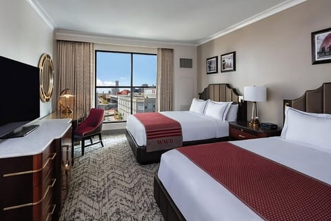 Unwind together in a bright double-queen room with city views.