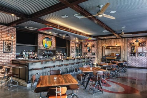 Gather at the lively bar for bites and local brews.