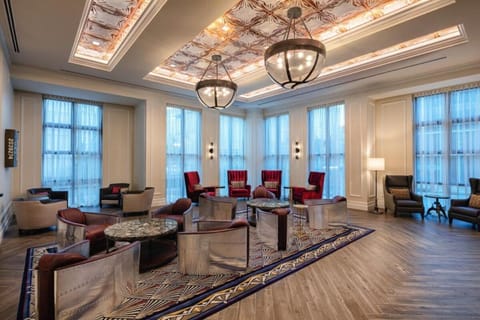 Unwind in the sunlit lounge with plush seating and cocktails.