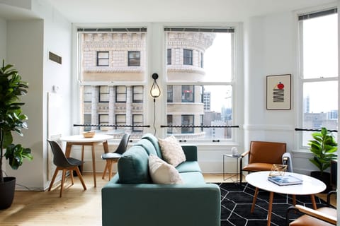 The open living room and dining area is flooded with light during the day