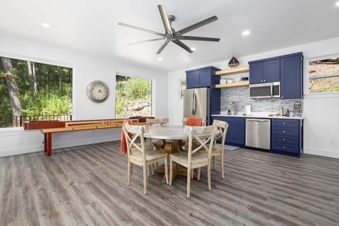 The game room has a kitchenette, a 65-inch Smart TV, a shuffleboard table, and plenty of board games.