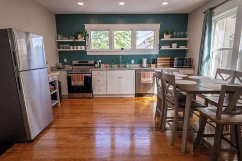 Experience the charm of a clean kitchen with wooden floors, blending functionality and warmth for a cozy culinary haven.