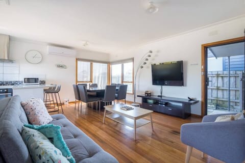 The relaxed, air-conditioned lounge area includes a sofa and an armchair where you can enjoy your favourite shows on the large mounted TV.