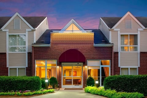 Arrive at a welcoming entrance glowing softly at dusk.