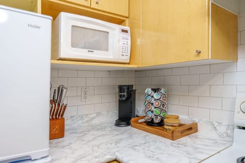 Equipped with a Keurig machine, stocked with an assortment of coffee pods.