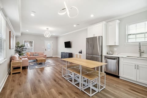 Living Into Kitchen- well equipped, ice maker, water dispenser, pot filler, stovetop and oven, coffee maker, coffee, creamer, sugar, filters, wine glasses, smart tv with streaming apps, designer lighting and seating for 12 plus