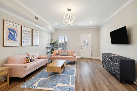 Living- smart tv with streaming apps, designer lighting and two sofas. 