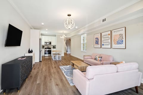 Living Into Kitchen- well equipped, ice maker, water dispenser, pot filler, stovetop and oven, coffee maker, coffee, creamer, sugar, filters, wine glasses, smart tv with streaming apps, designer lighting and seating for 12 plus