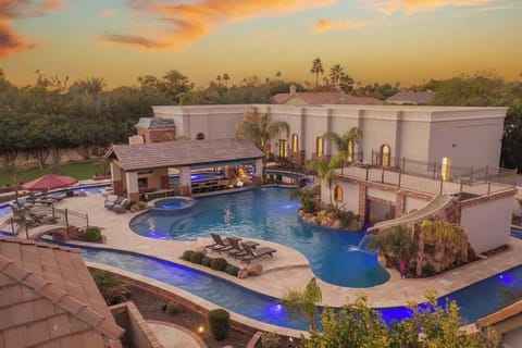 Bird’s-eye view of the ultimate backyard retreat—resort-style pool, lazy river, and water slides surrounded by tropical landscaping.