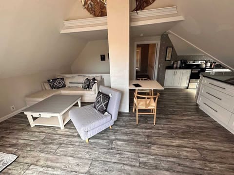 Living and dining space with vaulted ceilings