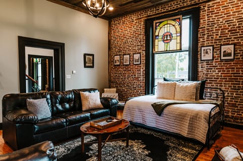 Living room includes 15' ceilings, stained glass window with black out shades