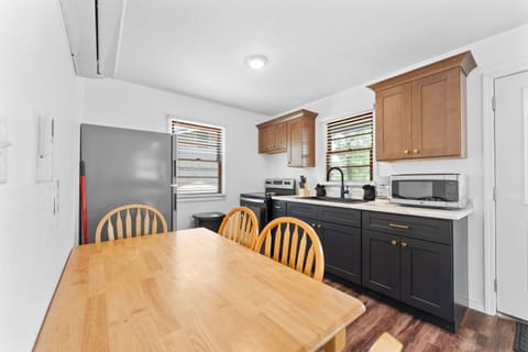 Where gourmet meals meet modern elegance   a kitchen and dining space designed for both cooking and sharing memories.