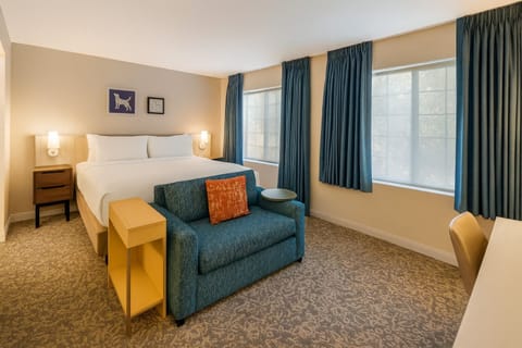 Unwind in a sunlit bedroom with plush linens and calm vibes.