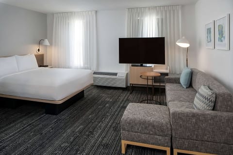 Unwind in a bright studio suite with sofa and king bed