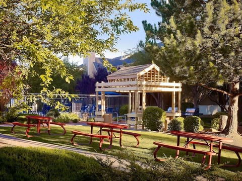Stroll through leafy grounds with picnic tables and shaded seating.