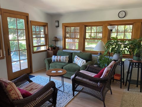 East living area overlooking yard, patio and deck