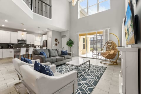 Modern open-plan living room with plush seating and smart TV for family movie nights.