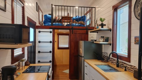 Fully functional kitchen with full refrigerator, gas oven and cooktop, microwave