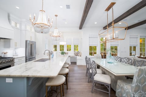 Elegant kitchen with marble counters, crystal chandeliers, and breakfast bar where you'll create culinary memories in sophisticated style.