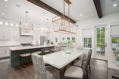 Gather around this stunning dining space where rustic beams meet modern elegance, perfect for memorable meals with loved ones.