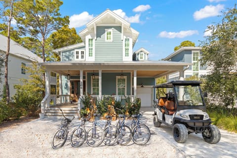 Charming coastal cottage with bikes and golf cart ready for exploring the neighborhood.