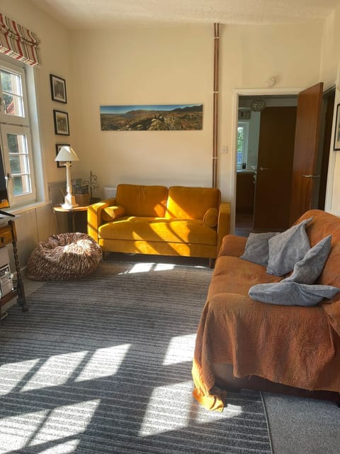 Lounge area with 2 settees, telly and record player.