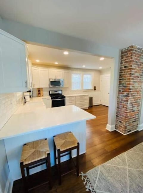 Kitchen including two barstools.