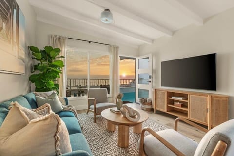 The living room offers a relaxing retreat with comfortable seating and thoughtful designer touches ideal for unwinding after a day at the beach.