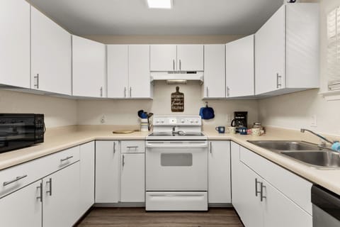 Cook with ease in a clean, bright kitchen fully stocked for family meals after a day of adventure