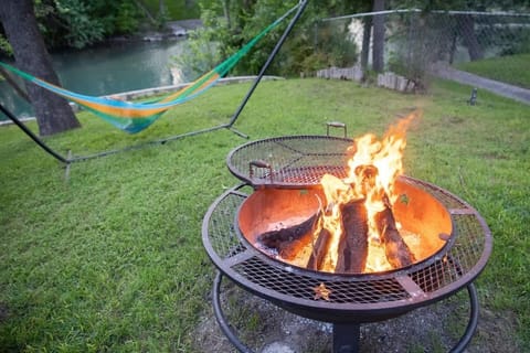 Private backyard along the Guadalupe River with hammock and fire pit for late night stories. Swim, fish, or float by day, then relax under the stars during your Spring Break getaway in New Braunfels.