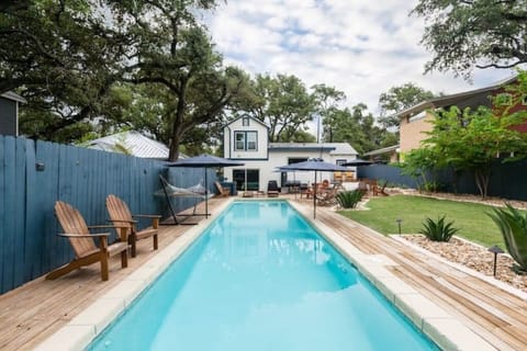 Private backyard pool oasis with grill, smoker, large picnic table, and fire pit